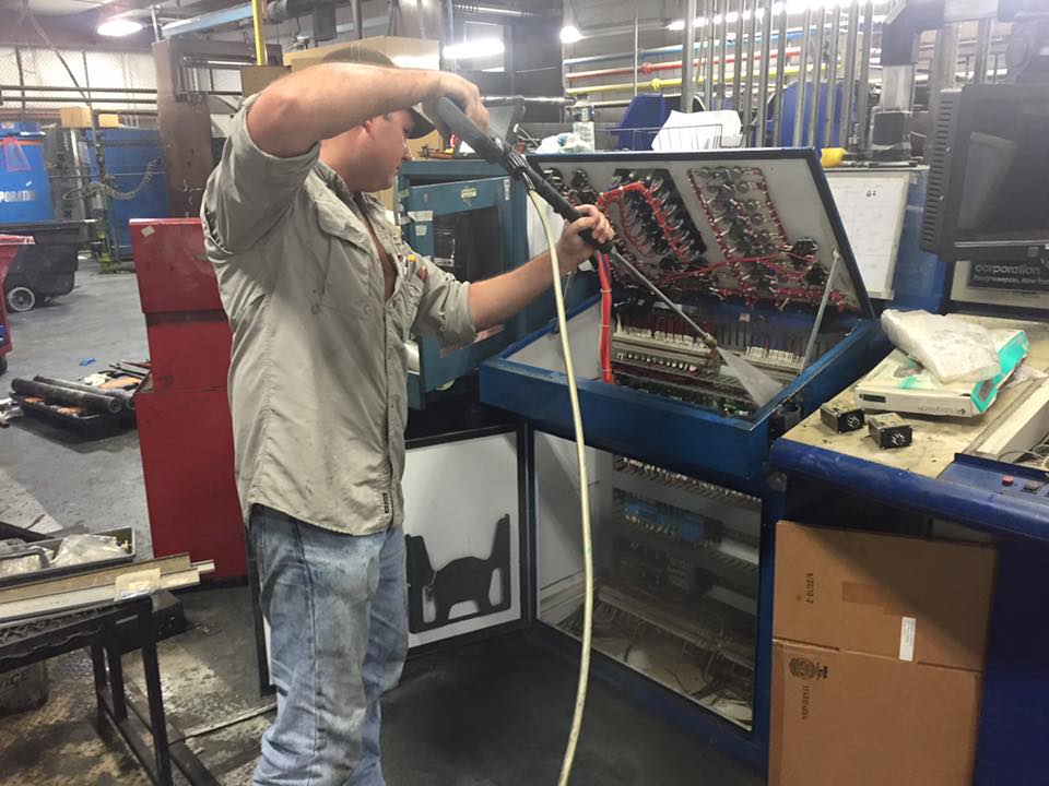 Fairchild uses a pressure sprayer on an electrical panel. No, it's not plugged in.